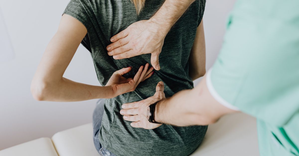 Person stretching their back and neck to ease posture-related discomfort