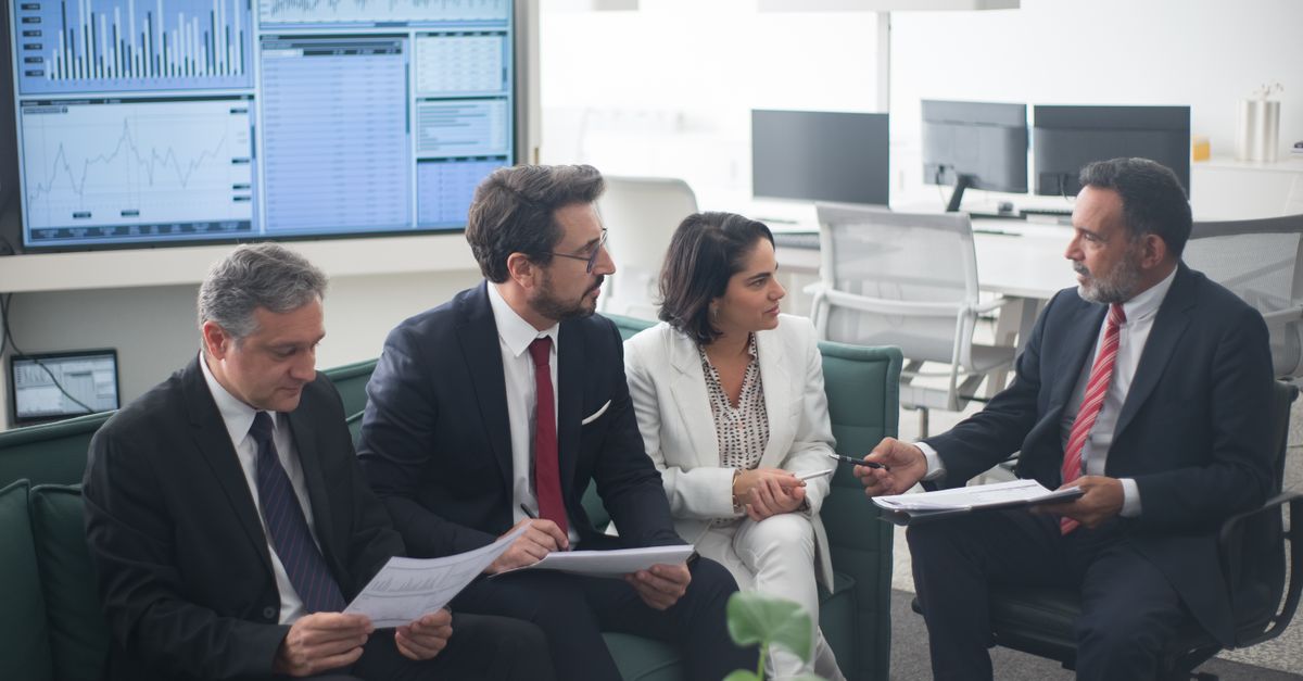 Two Ottawa financial advisors planning a client growth strategy at a meeting table