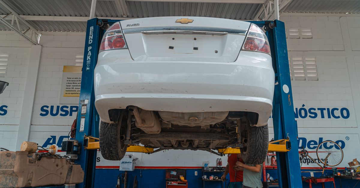 Technician using a diagnostic scan tool on a customer vehicle
